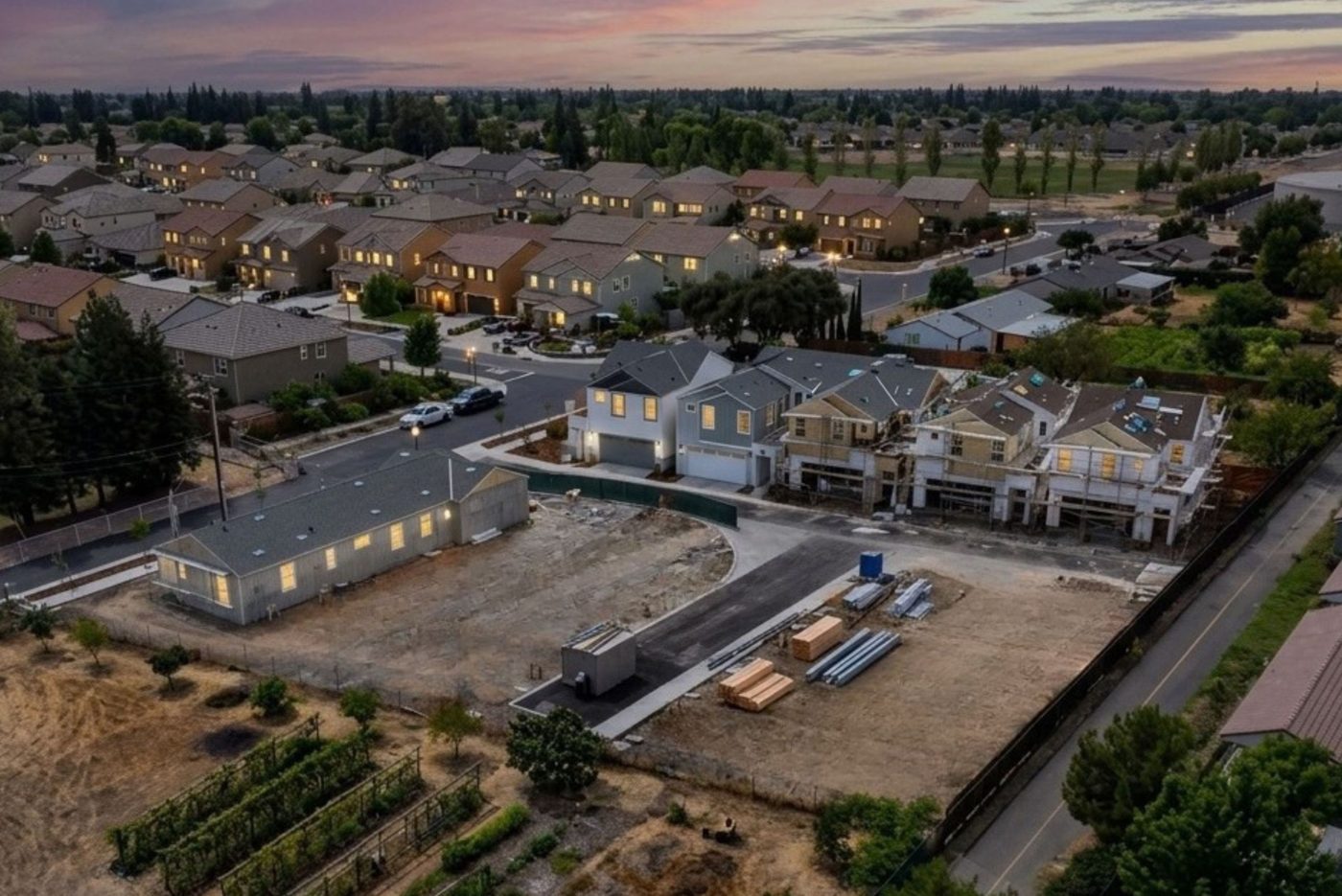 Courtyards at Cotton Lane — Aerial view of the community under construction at dusk