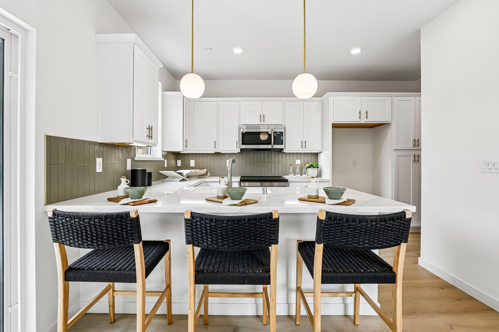 Courtyards at Cotton Lane — Kitchen with island seating and pendants