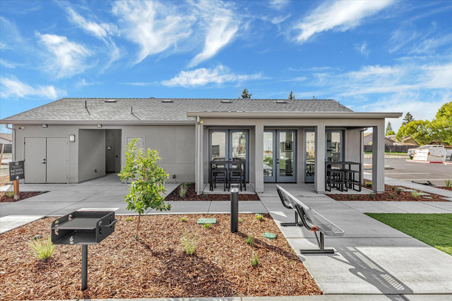 Northpointe Reserve clubhouse exterior with BBQ grill and benches