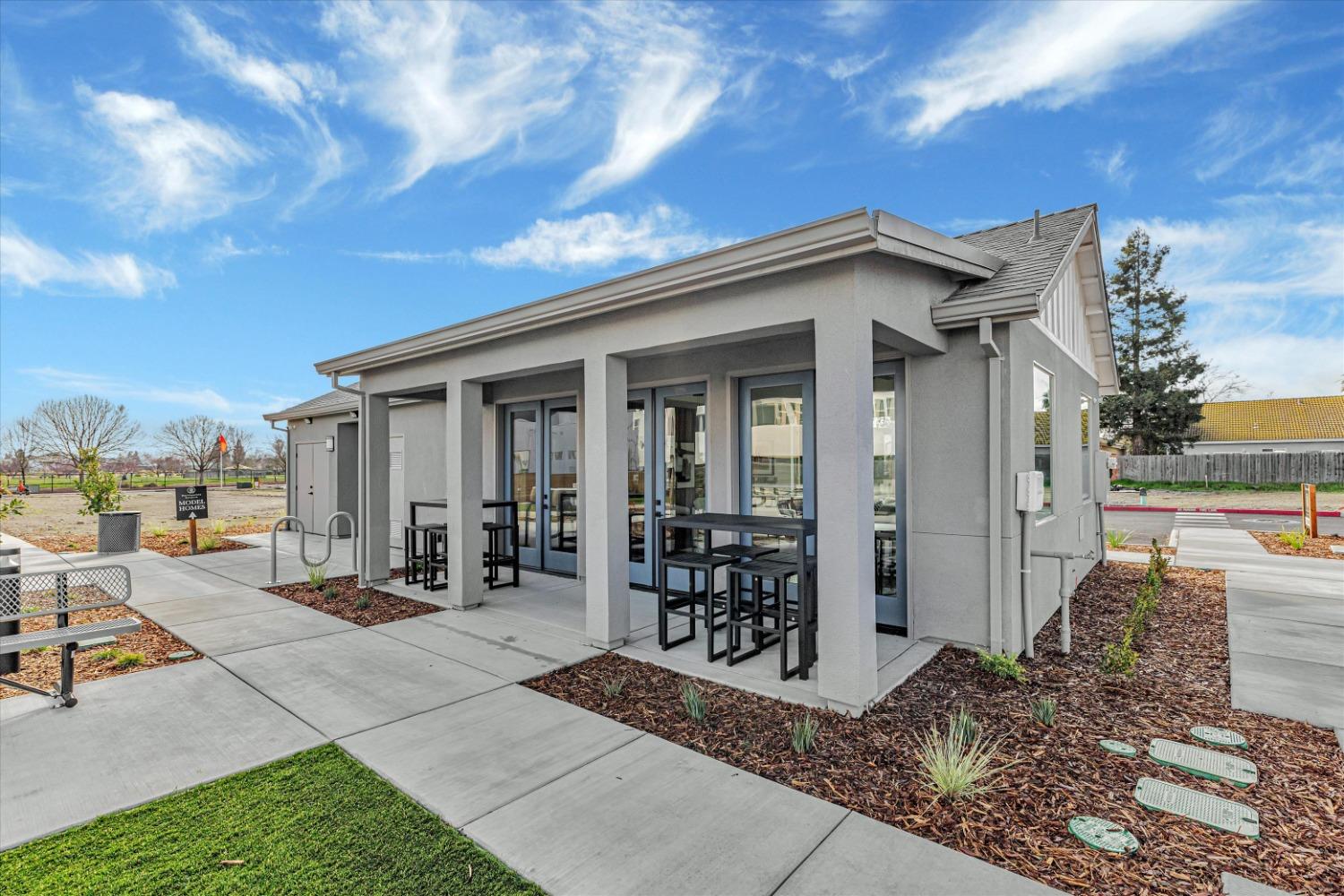 Clubhouse exterior with outdoor bistro seating