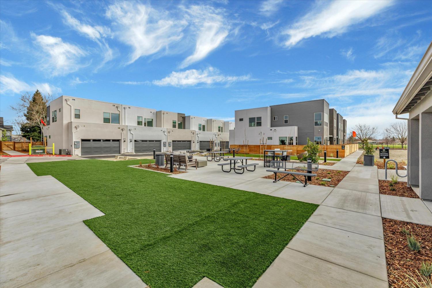 Community park turf and picnic tables framed by Northpointe homes